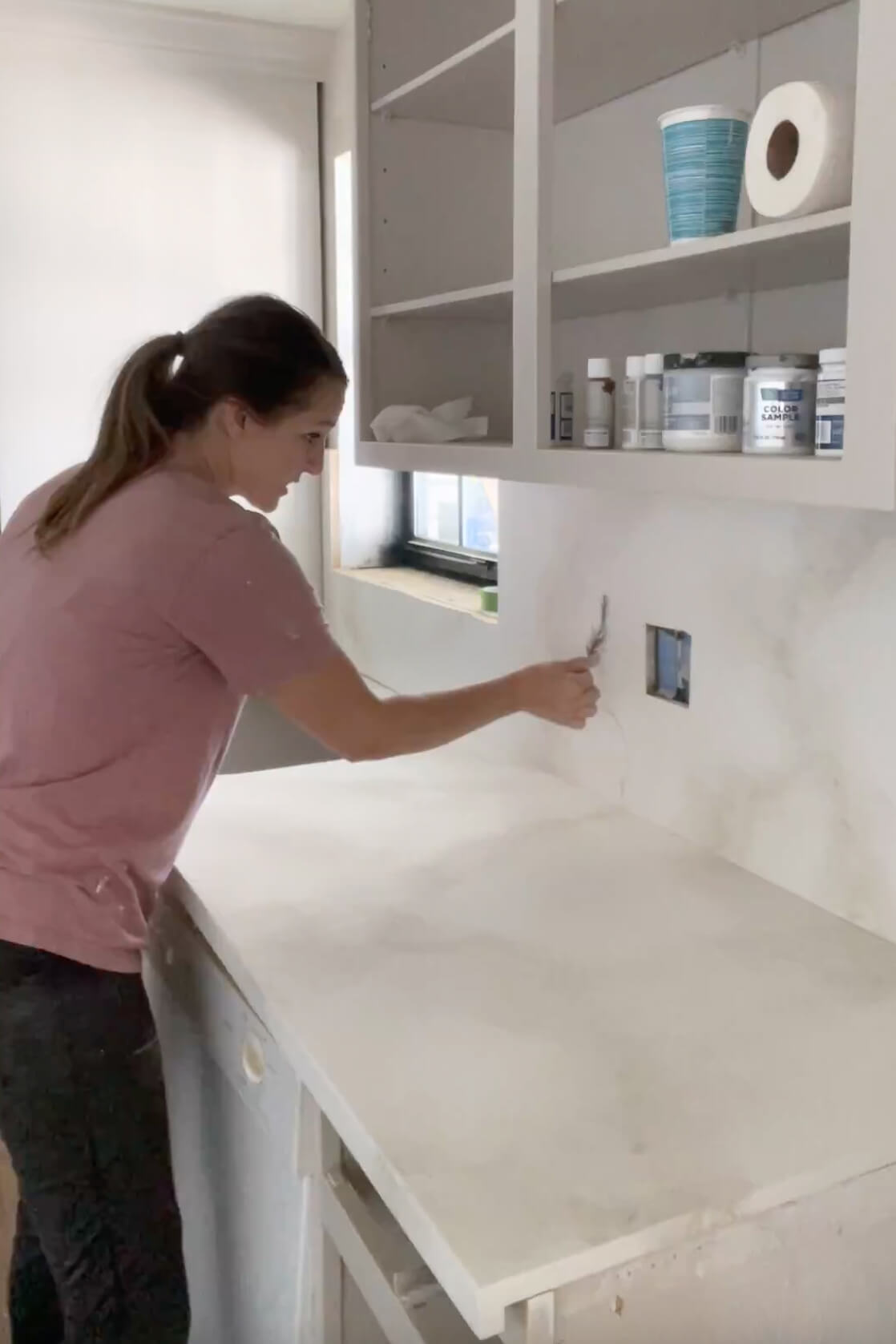 Painting a countertop for a faux marble finish. 